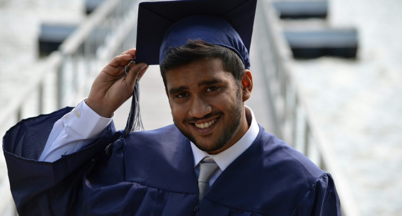 man holding his graduation cap