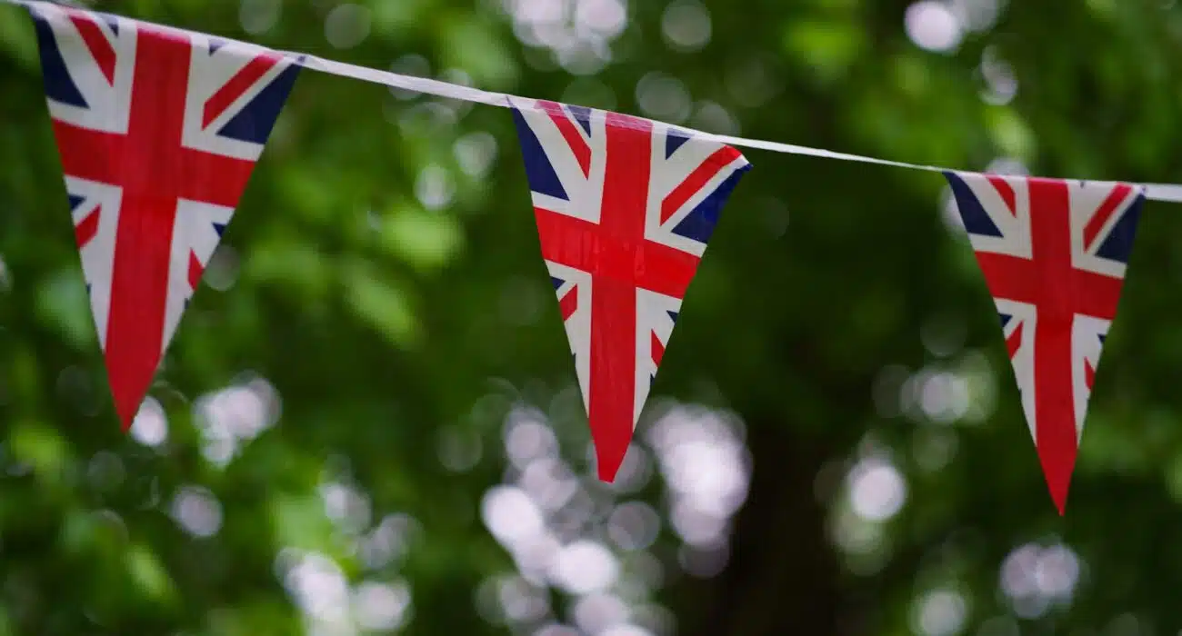 a british flag bunting on a tree line